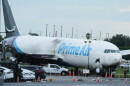 Workers inspect an Amazon cargo plane that overshot a runway four days ago at Miami International Airport, Thursday, Sept. 10, 2026, in Miami.