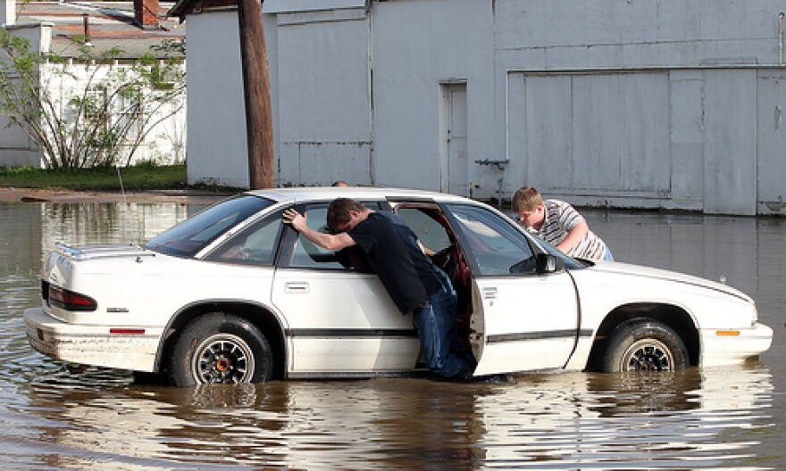 Young boys attempt to push a car from flood waters in downtown Poplar Bluff, Missouri on April 26, 2011. A levee on the Black River protecting the area from major flooding has breached in several places, forcing authorities to evacuate residents.