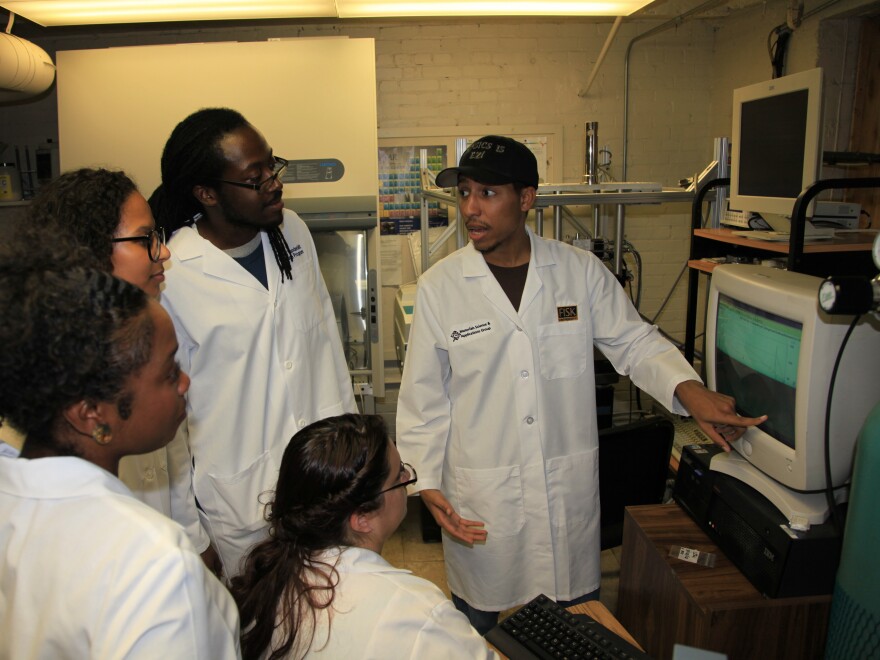 Fisk University physics student Terreka Hart (foreground, left) looks on with a group of students from the Bridge Program — Melanie Brady, Bobby Jones, Rose Perea (seated) and Brenden Wiggins (pointing).