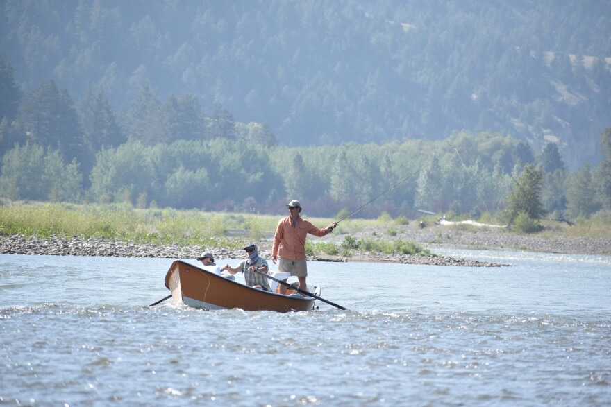 A drift boat with people fly fishing floats down the Yellowstone River, Friday, July 31, 2026, near Livingston, Montana.