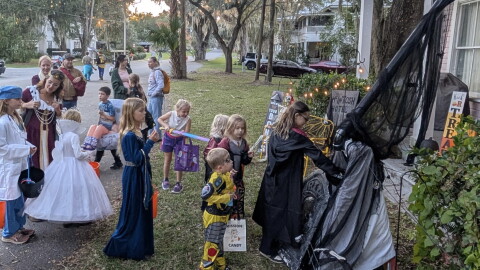 Children line up at McIntosh Mayor Alison Scott’s two-story house, which was built in 1895 as the town’s hotel, to receive candy from a PVC pipe chute on Halloween. (Courtesy of Alison Scott)