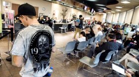 People standing and sitting in a DMV office.