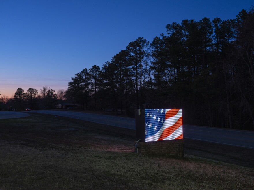 A sign outside Nottoway High School shows an animation of the American flag.