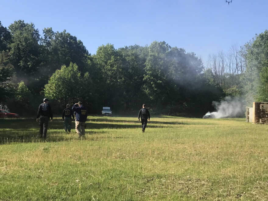 Safety officials check the exploded cars before IUPUI students investigate the wreckage at Eagle Creek Pistol Range on Friday, June 14, 2019.