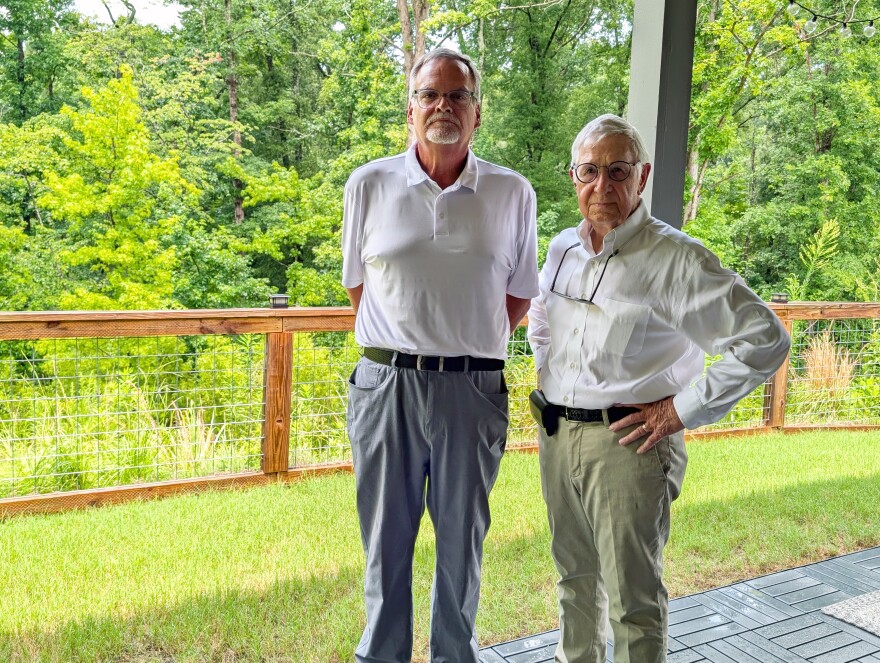 Neighbors John Hilley and Rob Sansome stand on Sansome's back porch.