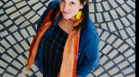 KALW DJ Charlotte K standing on a tiled floor looking up at the camera