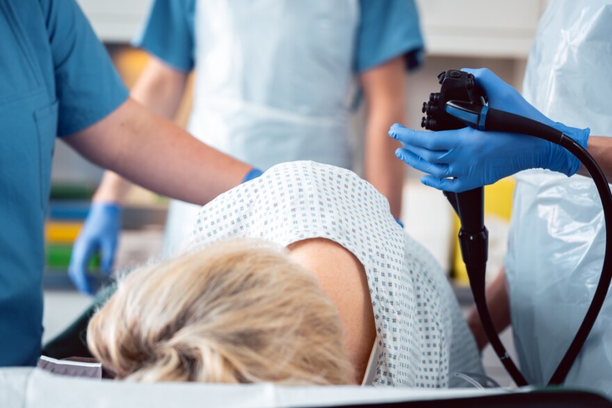 Patient and doctor in a hospital during colonoscopy, closeup