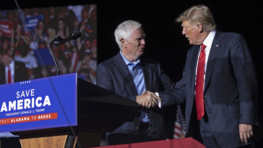 Former President Donald Trump welcomes Rep. Mo Brooks, R-Ala., a candidate for U.S. Senate, to the stage during a rally in Cullman, Ala., on Aug. 21, 2021. Trump on Wednesday pulled his endorsement of Brooks, who's been struggling in polls.