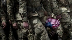 Soldiers in the Old Guard arrive to place flags at graves in Arlington National Cemetery during "Flags In" in preparation for Memorial Day May 25, 2017 in Arlington, Virginia. (Brendan SmialowskiI/AFP via Getty Images)