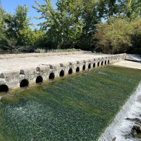 Water flows through a low-head dam.