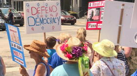 Demonstrators gathered in front of U.S. Sen. Todd Young (R-Ind.)'s office before marching to the office of U.S. Sen. Mike Braun (R-Ind.) a few blocks away.