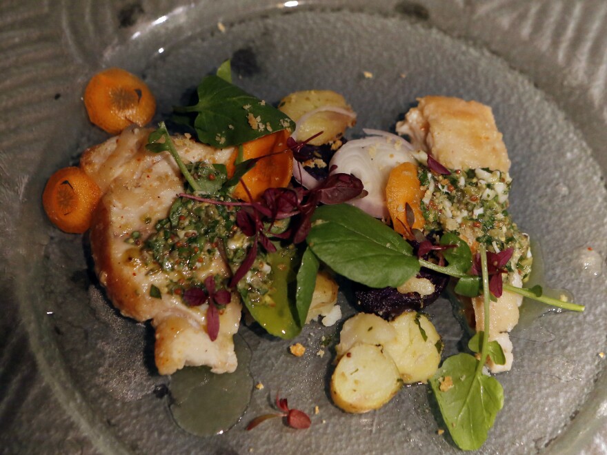 Diners' knowledge of frequently mislabeled fish was tested with an escabeche-style grouper, left, paired with an escabeche-style weakfish, right, and potatoes between them.