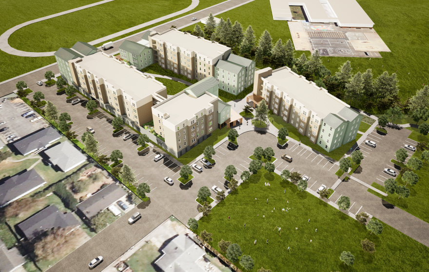 A computer rendering shows brown and teal five-story buildings from above. They're surrounded by fields and parking lots. 