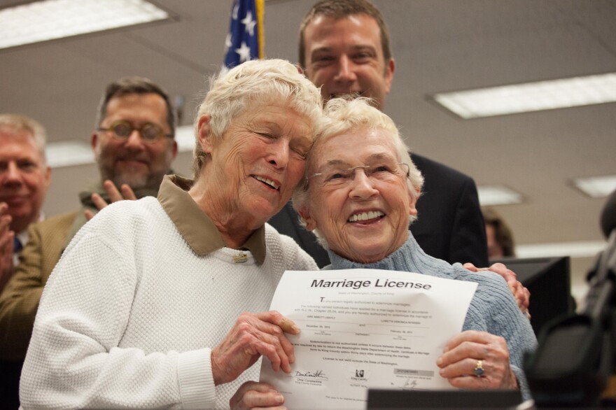 Jane Abbott Lighty, left, and Pete-e Petersen embrace after receiving the first same-sex marriage license in Washington state at the King County Recorder's Office in Seattle, Washington.