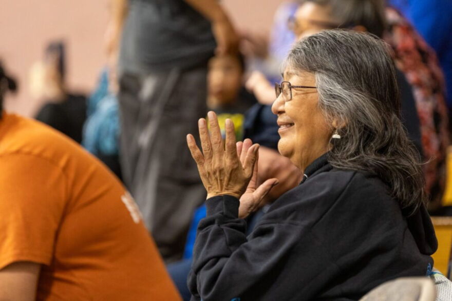 Lucy Kitchen looks on dancers from the crowd at the 25th Annual Kingikmiut Dance Festival.