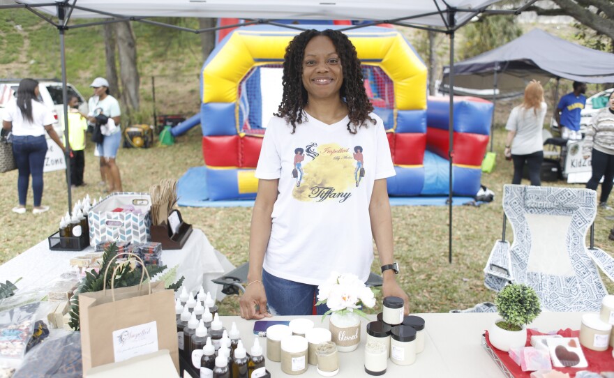 Tiffany Hagan poses in front of her booth Impelled by Ardor during the 2022 Publix Tampa Bay Collard Festival in St. Petersburg, Florida, on Saturday, February 19, 2022. Photo by Octavio Jones for WUSF