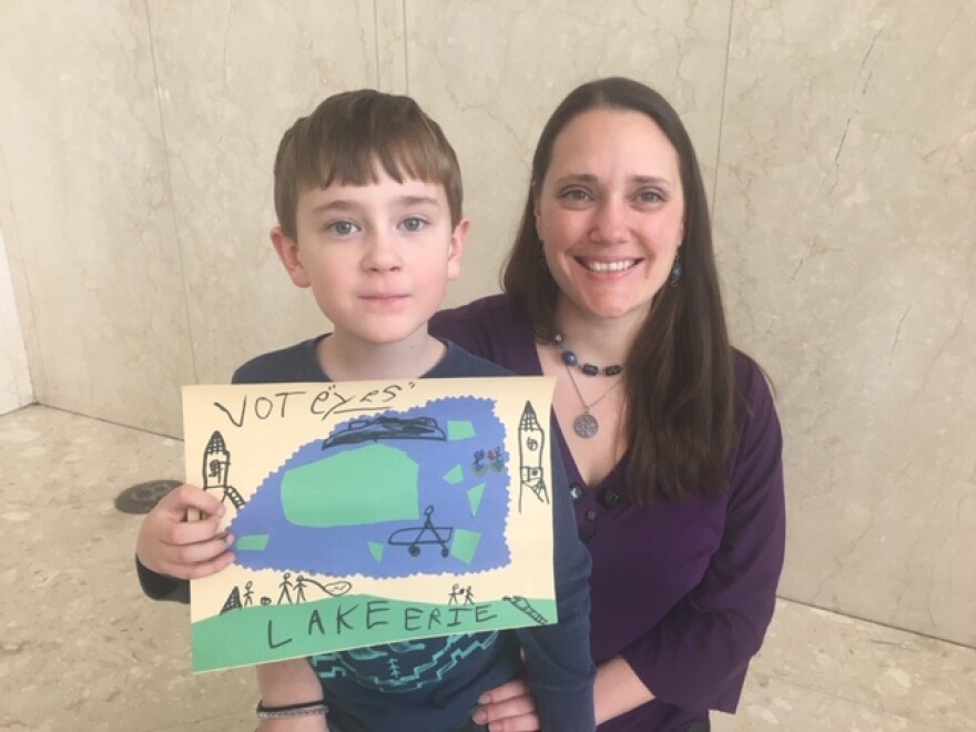 Stefania Czech, Toledoan for Safe Water member, and her 6-year-old son, Mirek, participate in a press conference denouncing outside money funding negative ads against the charter amendment