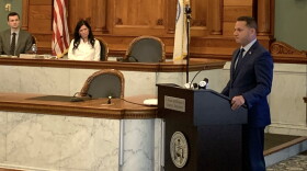 County Executive Ryan McMahon delivers his budget address to the legislature as Chairwoman Watts looks on.