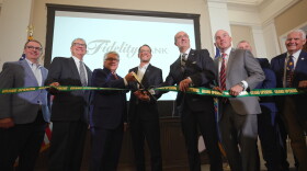 Daniel J. Santaniello, Fidelity Bank President and Chief Executive Officer, cuts a ribbon to open the bank's new corporate headquarters alongside Pennsylvania Governor Josh Shapiro and other bank and elected officials.