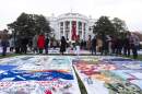 AIDS survivors, their families and advocates look at the display of AIDS Memorial quilts spread over the South Lawn of the White House during a ceremony to commemorate World AIDS Day, Sunday, Dec. 1, 2024, in Washington. (Manuel Balce Ceneta/AP)