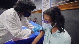 Jackson-Hinds Comprehensive Health Center nurse Maggie Bass, left, gives Ayana Campbell, 14, a dose of the Pfizer vaccine at an open COVID-19 vaccination site sponsored by the university and the medical center in the Rose E. McCoy Auditorium at Jackson State University in Jackson, Miss., Tuesday, July 27. (Rogelio V. Solis/AP Photo)