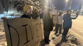 Protesters hold signs outside the Westmark Hotel in Fairbanks Nov. 18, 2025, to protest NANA's contracts with Immigration and Customs Enforcement (ICE) to provide security services at detention centers.