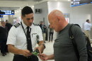 Local members of the National Air Traffic Controllers Association stop passengers to talk about the impact of the government shutdown on airport workers in the Miami International Airport on Wednesday, Jan. 16, 2019.  