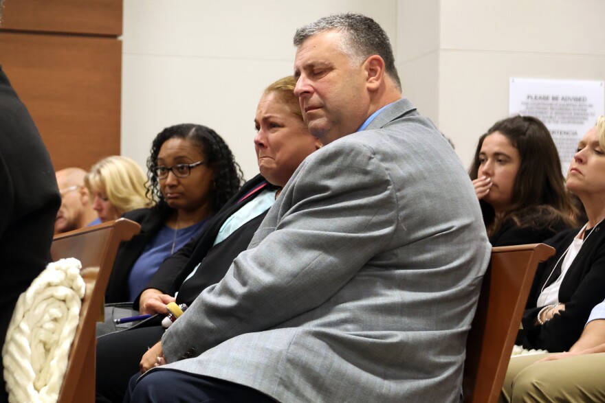 Jennifer and Tony Montalto listen to Dr. Marlon Osbourne, Assistant Medical Examiner for Palm Beach county testify about the gunshot wounds their daughter Gina Montalto sustained in the mass shooting. Nikolas Cruz is being tried in the penalty phase of his trial at the Broward County Courthouse in Fort Lauderdale on Wednesday, July 26, 2022. Cruz previously plead guilty to all 17 counts of premeditated murder and 17 counts of attempted murder in the 2018 shootings. (Mike Stocker/South Florida Sun Sentinel via AP, Pool)