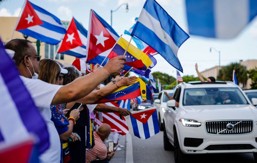 People hold Cuban, Venezuelan and Nicaraguan flags during a protest showing support for Cubans demonstrating against their government in Miami on July 18. The US. Latino population has grown significantly in the last decade.