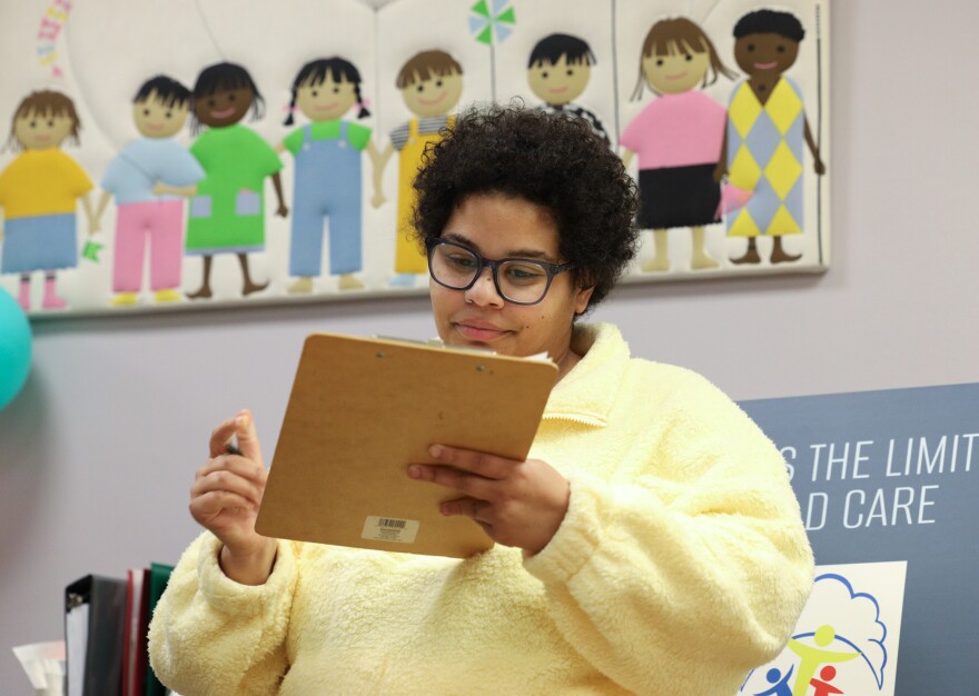 Madeline Brown signs in a child to the Monroe County Court's, Children’s Center in the Hall of Justice (Room 300), providing child care for families navigating the court system. The center is open from 9 a.m. to 5 p.m. for children ages 6 weeks to 12 years and is operated by Skies the Limit Academy, offering a safe, supervised play space while guardians attend to legal matters.