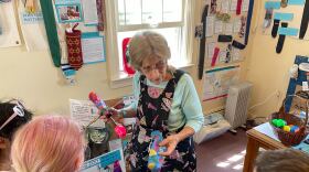 Umbrella Cover Museum founder Nancy Hoffman gives a tour to a visiting class of students.