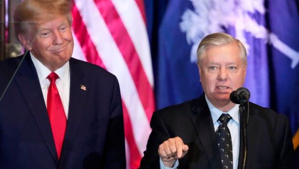 FILE - Former President Donald Trump listens as Sen. Lindsey Graham, R-S.C., speaks at a campaign event at the South Carolina Statehouse, Jan. 28, 2023, in Columbia, S.C. (AP Photo/Alex Brandon, File)