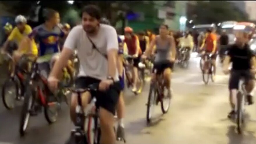 A video screengrab shows riders in the Critical Mass bike ride last Friday, seconds before a car sped through the Porto Alegre street.