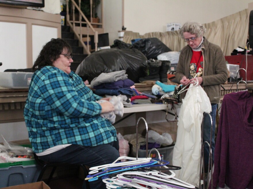 Roxanne Lent folds clothes for The Storehouse, a clothing ministry of Biker Church USA in Bangor, Maine.