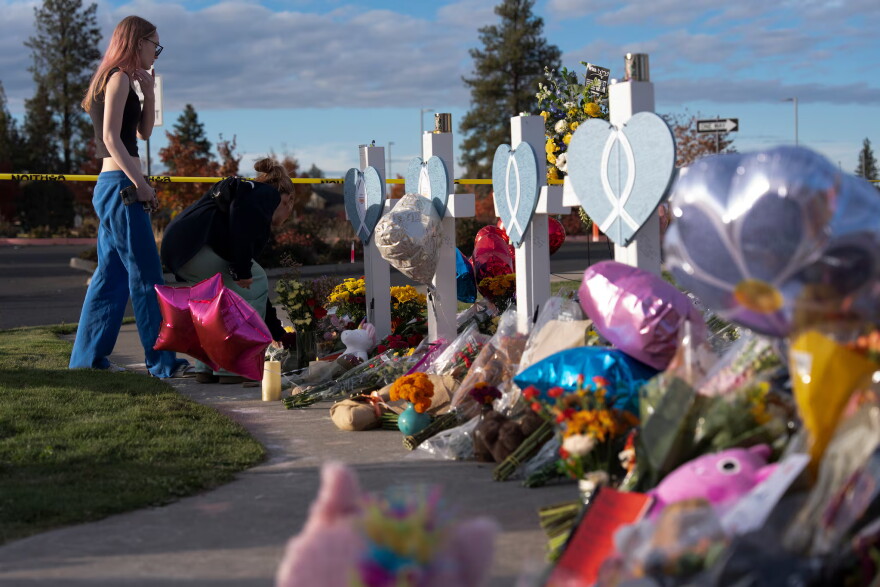 Mourners visit the memorial outside Silver Rail Elementary School on Oct. 17, 2026, in Bend, Ore.