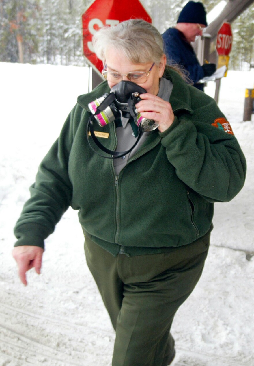 Snowmobile exhaust has been so bad that respirators like this one worn by park worker Kitty Eneboe in 2003 have been needed for protection.