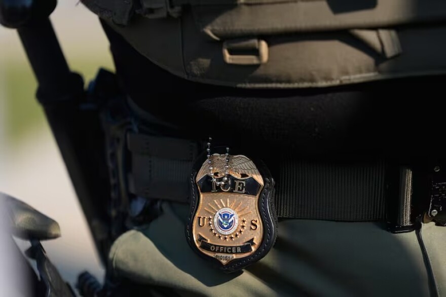 FILE - A badge on the hip of an Immigration and Customs Enforcement agent in Broadview, Ill., Oct. 3, 2025.