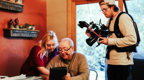 Producer Christopher Larson (right) records Dominique and her father at home in Spearfish, SD.