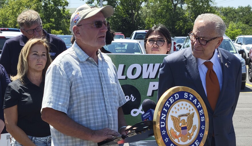 Farmer Ken Post of Post Family Farm in Scipio, Cayuga County speaks at a press conference on food prices held by Sen. Chuck Schumer, at right.
