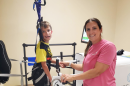 Pediatric therapist Sarah Prebich helps her patient Liam in the Rise&Walk.