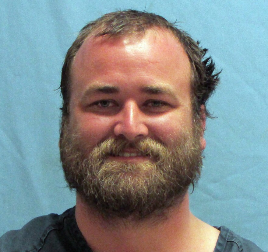 Michael T. Reed of Van Buren, Ark., was booked into the Pulaski County jail on Wednesday morning. He faces preliminary charges of defacing an object of public respect, trespassing and criminal mischief.