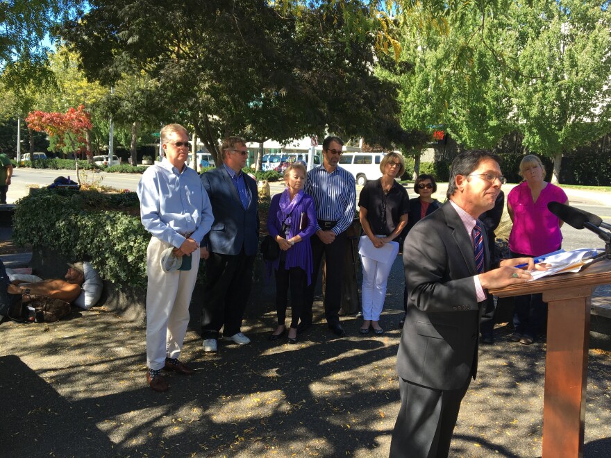 Republican state Sen. Mark Miloscia gives a press conference in front of a small group of homeless people. Miloscia says the homeless need more supervision.
