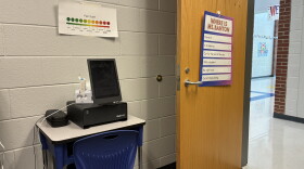School office with desk and computer screen used for telehealth 