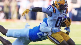 FILE - LSU wide receiver Zavion Thomas (0) is tackled by Mississippi linebacker Tahj Chambers (26) during the second half of an NCAA college football game in Oxford, Miss., Sept. 27, 2025. (AP Photo/Rogelio V. Solis, File)