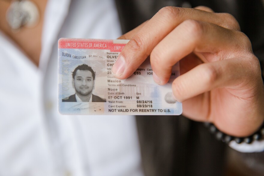Christian Olvera, 26, a DACA recipient, shows his Employment Authorization Card, which expires later this year.
