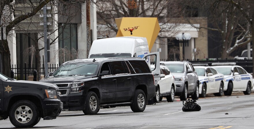 A drone and remote robot are used by law enforcement to investigate a report of a suspicious van parked in front of the Rochester Federal Building in this file photo from February 27, 2020. Rochester police said the area was cleared for traffic and that no dangerous devices had been found.