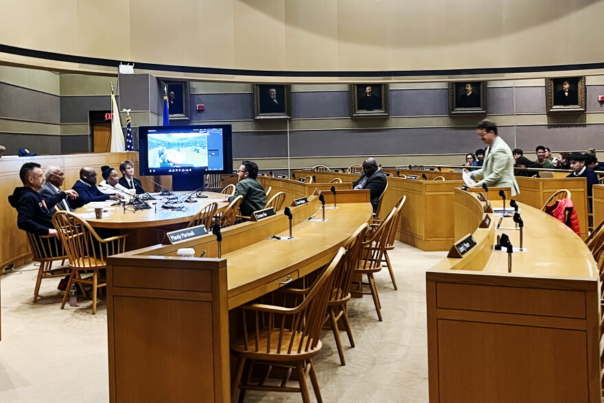 "Two Yale graduate students testify before the New Haven Board of Alders in favor of resolution urging Yale not to settle with the federal government."