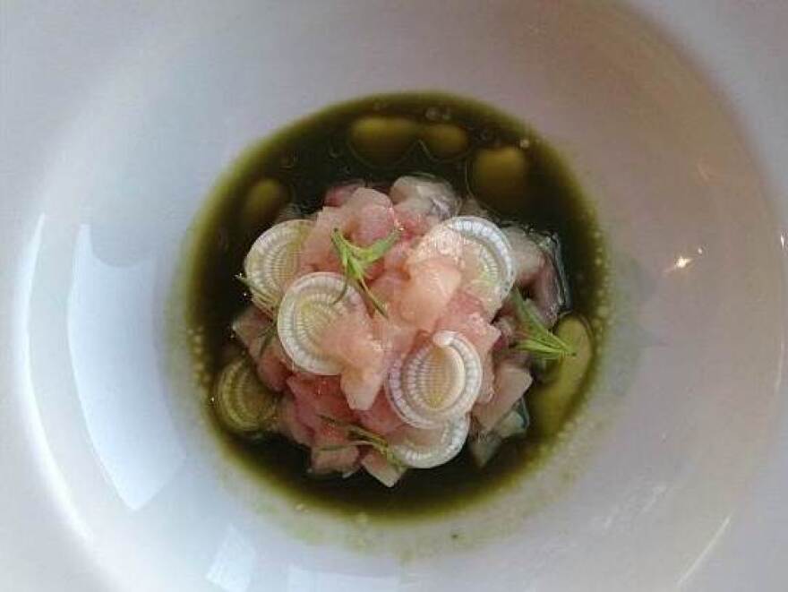 Hamachi with cattail, verbena, finger lime, white fir and sorrel broth at Girasol in Los Angeles.