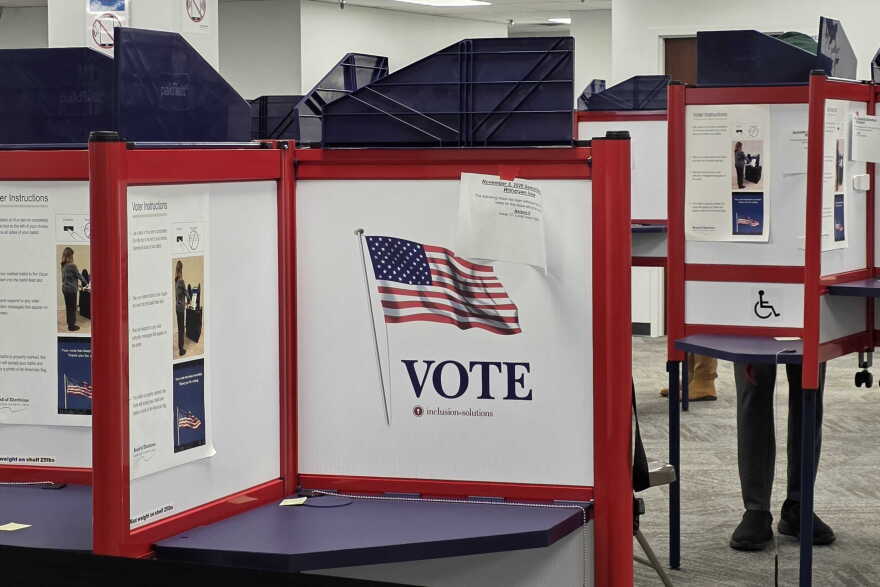 Polling booths with "vote" signs 