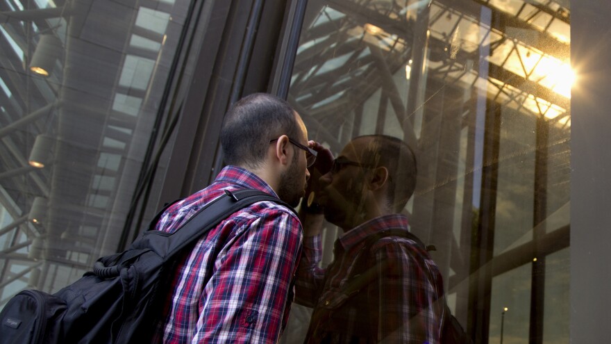 Rasim Akin Sevimli of Turkey tries to peer through the glass of the closed Smithsonian National Air and Space Museum on Tuesday — his only chance to see the museum before leaving Washington, D.C.